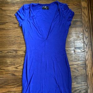 Low cut tight blue dress with bottom slit